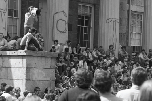 Old Capitol drew scores of anti-war student protestors, some who spelled out 'ROTC' on the building's four pillars.