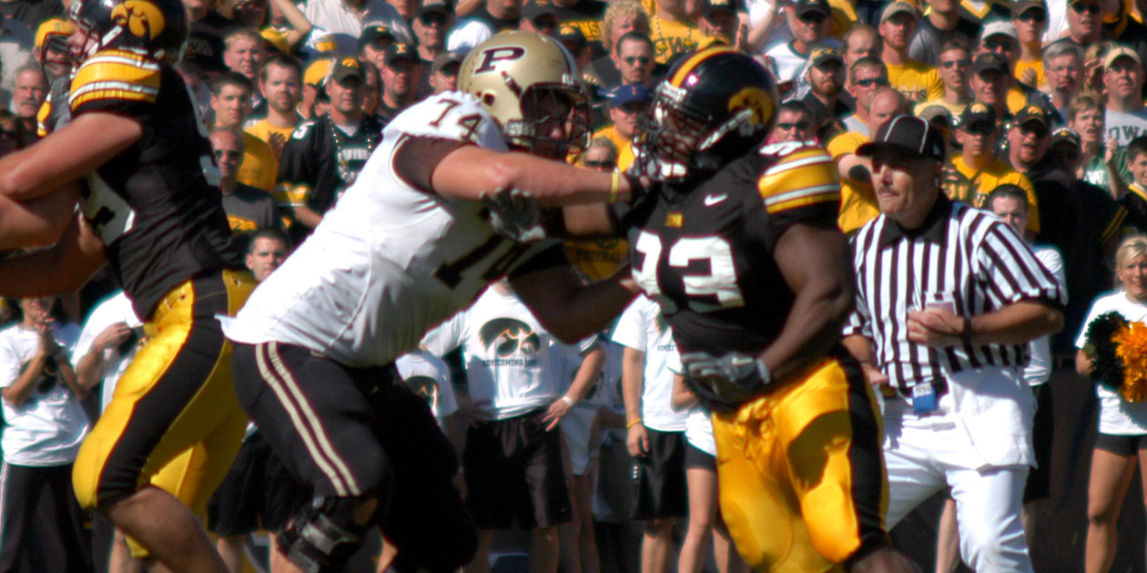 Ettore Ewen playing football for the Hawkeyes