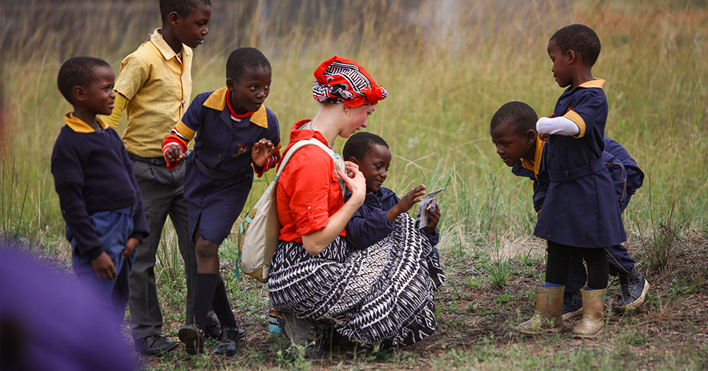 Alyssa Nahnsen (24BSN) makes friends with children from the Mnyafula Primary School outside of Siteki, Eswatini, during the University of Iowa public health nursing practicum abroad in spring 2024.