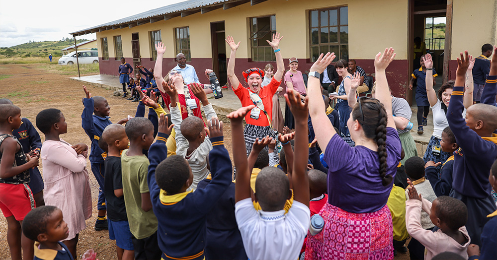 Alyssa Nahnsen (24BSN) interacts with a group of students from Mynyafula Primary School in rural Eswatini during a UI public health nursing practicum abroad.